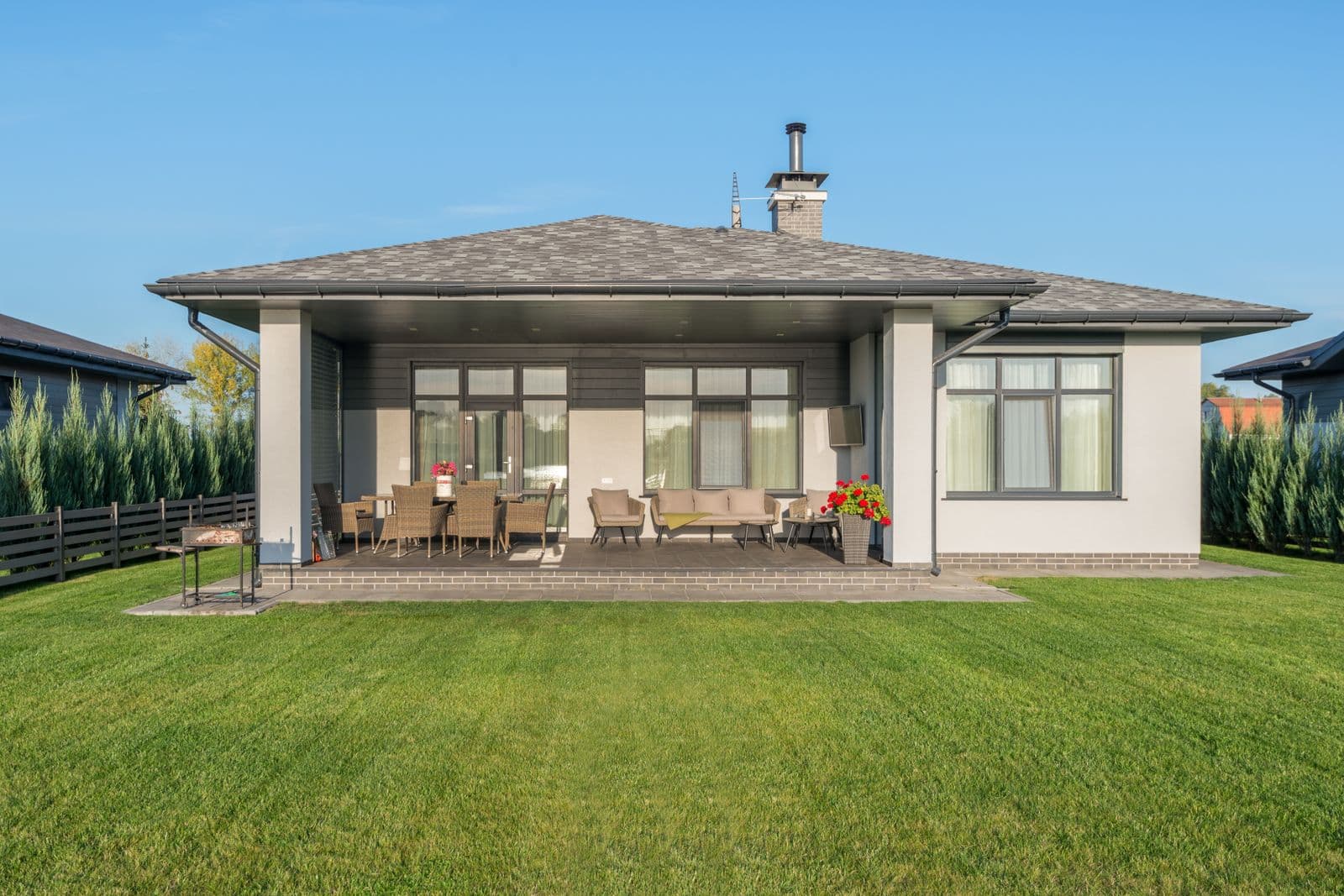 A beautifully landscaped garden with manicured lawn and patio